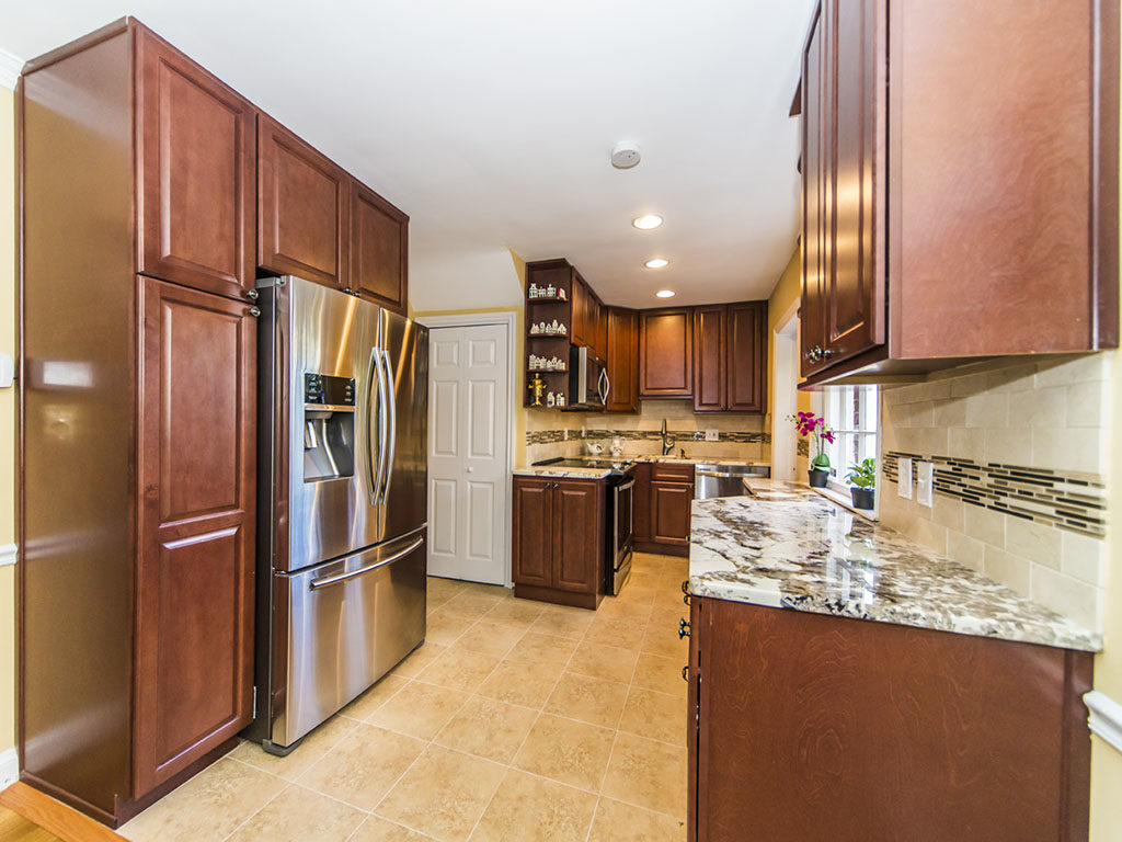Traditional kitchen style with brown cabinets and granite countertop
