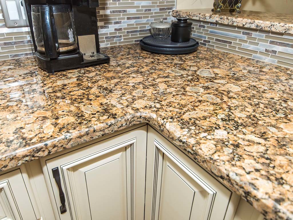 Cream, L style kitchen with traditional cabinets and granite countertop