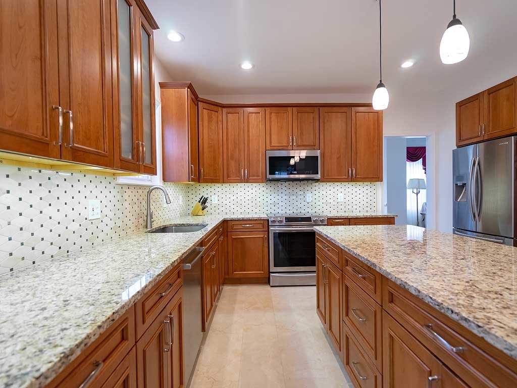 Transitional kitchen style with brown cabinets and granite countertop