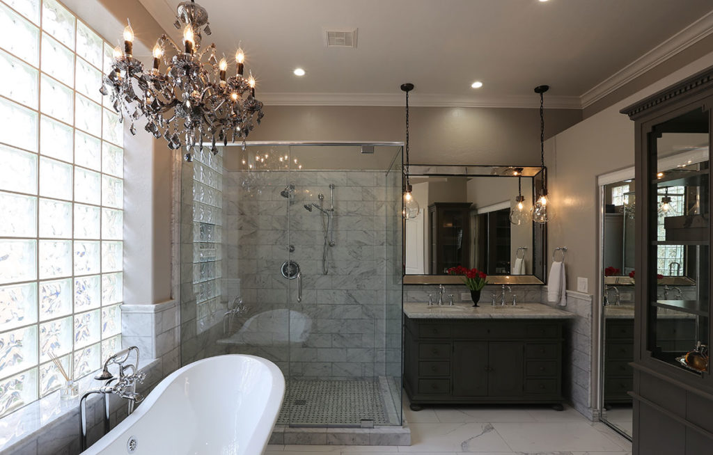 Elegant bathroom style with tub, shower, and a vanity