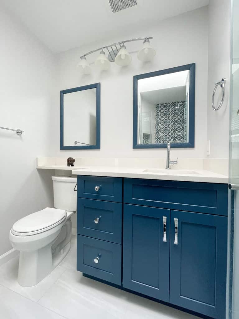 White bathroom with toilet and blue vanity