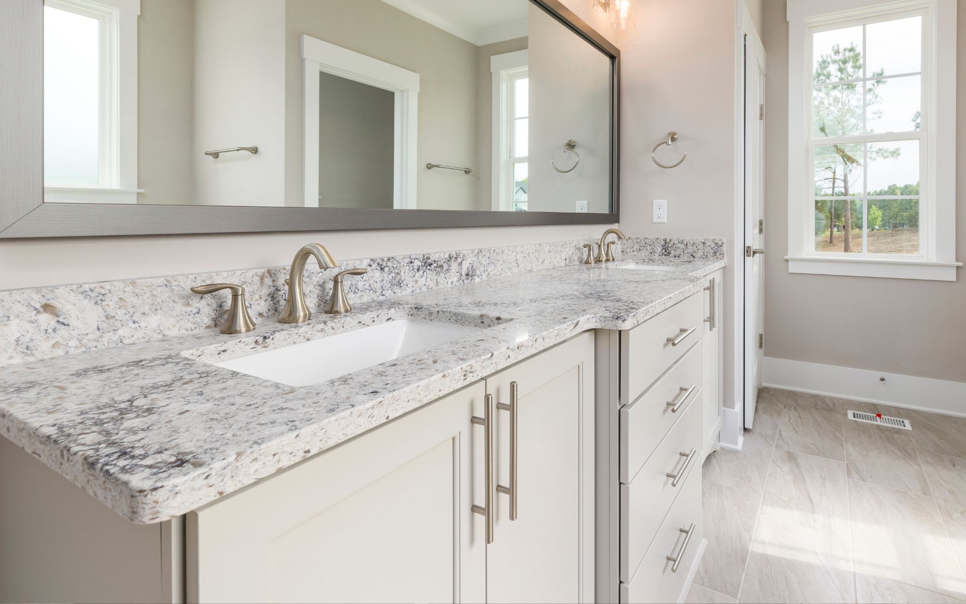 Bathroom with elegant white countertop, and cabinet
