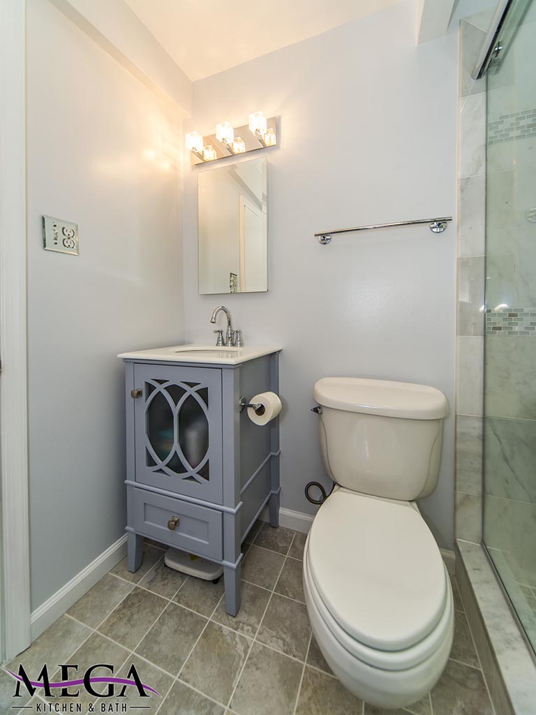 Small bathroom toilet and gray vanity