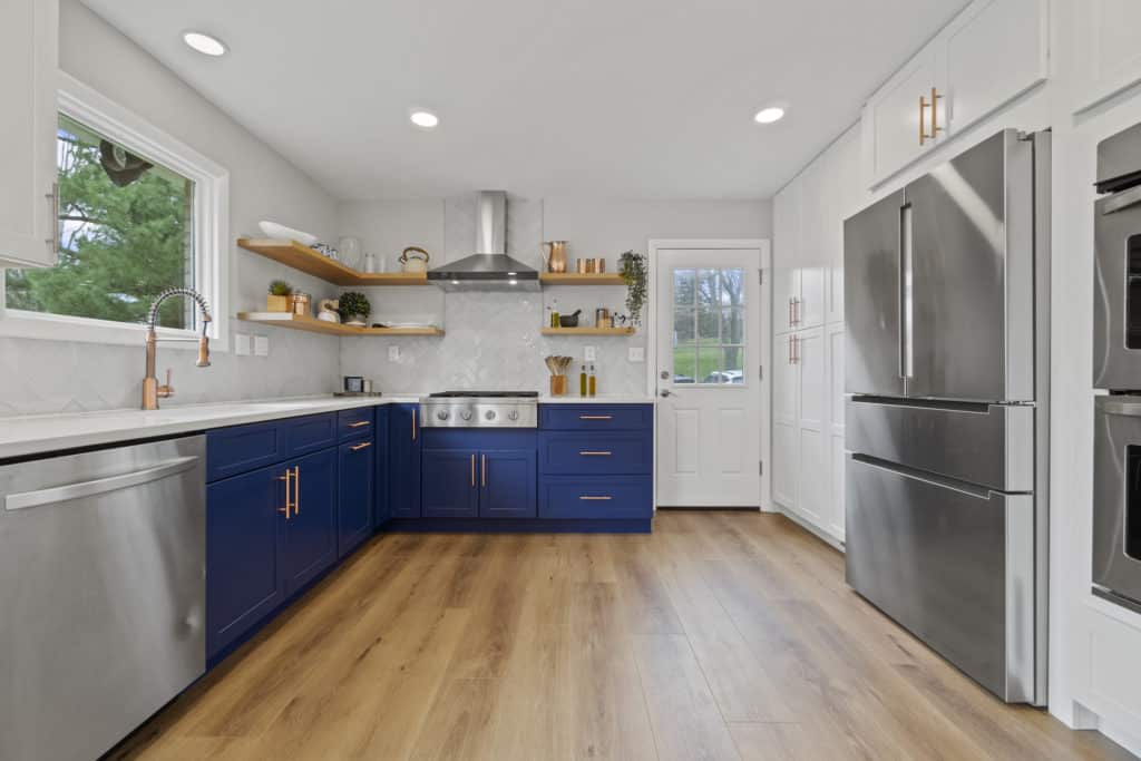 Simple L type kitchen with blue shaker cabinets and open shelving
