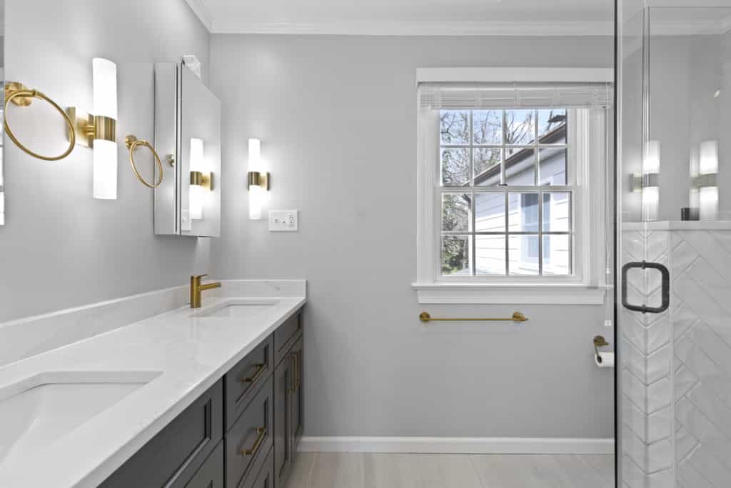 Light grey bathroom with dark grey vanity and white countertop
