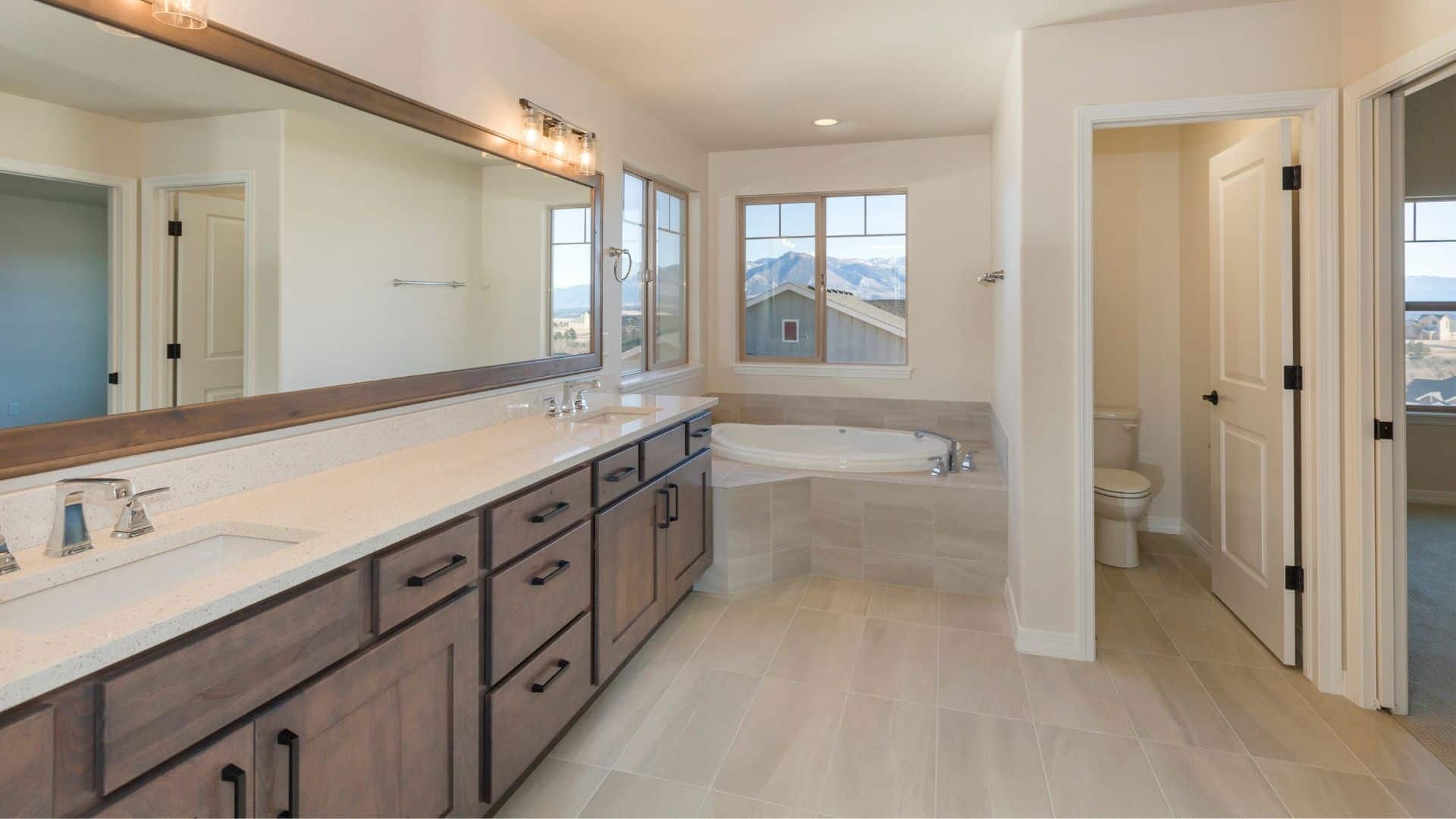 Elegant, spacious bathroom with double-sink vanity, and tub