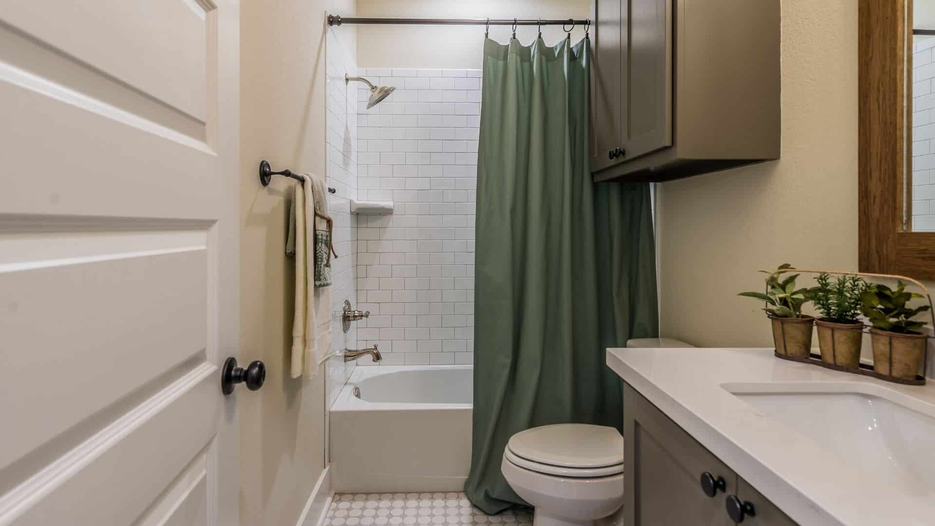Small bathroom with vanity, toilet, and tub shower combination