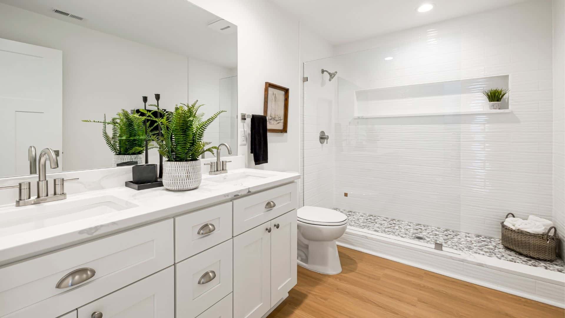 Spacious bathroom with white cabinet, toilet, and shower