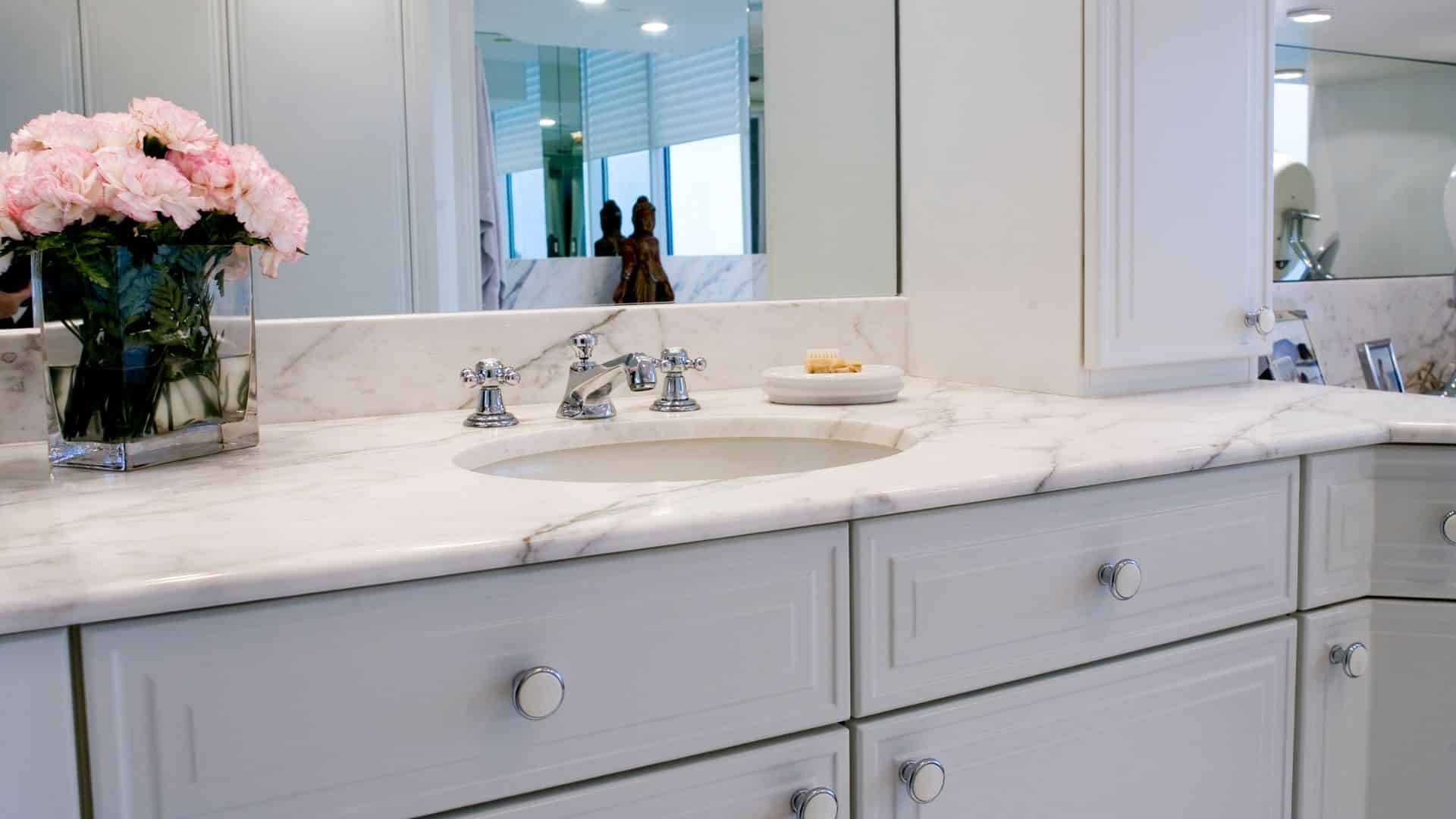 Elegant bathroom with marble countertop and gray cabinets