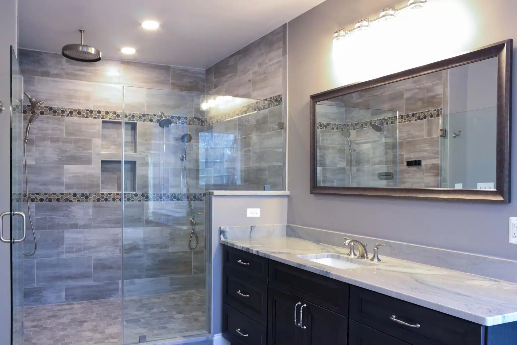 Elegant bathroom design with dark brown vanity and a shower