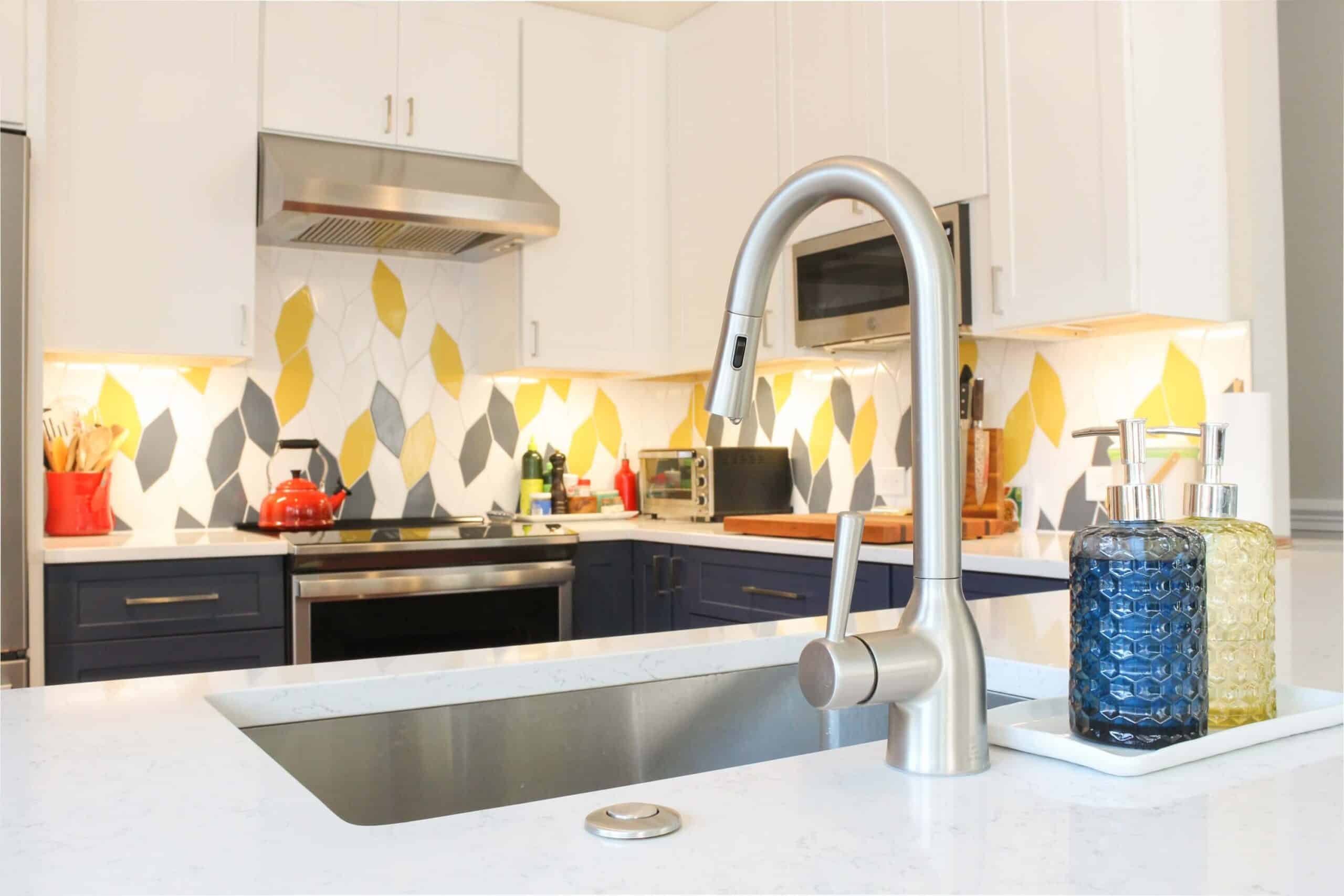 Fancy kitchen design with white and navy blue cabinets, and white countertop