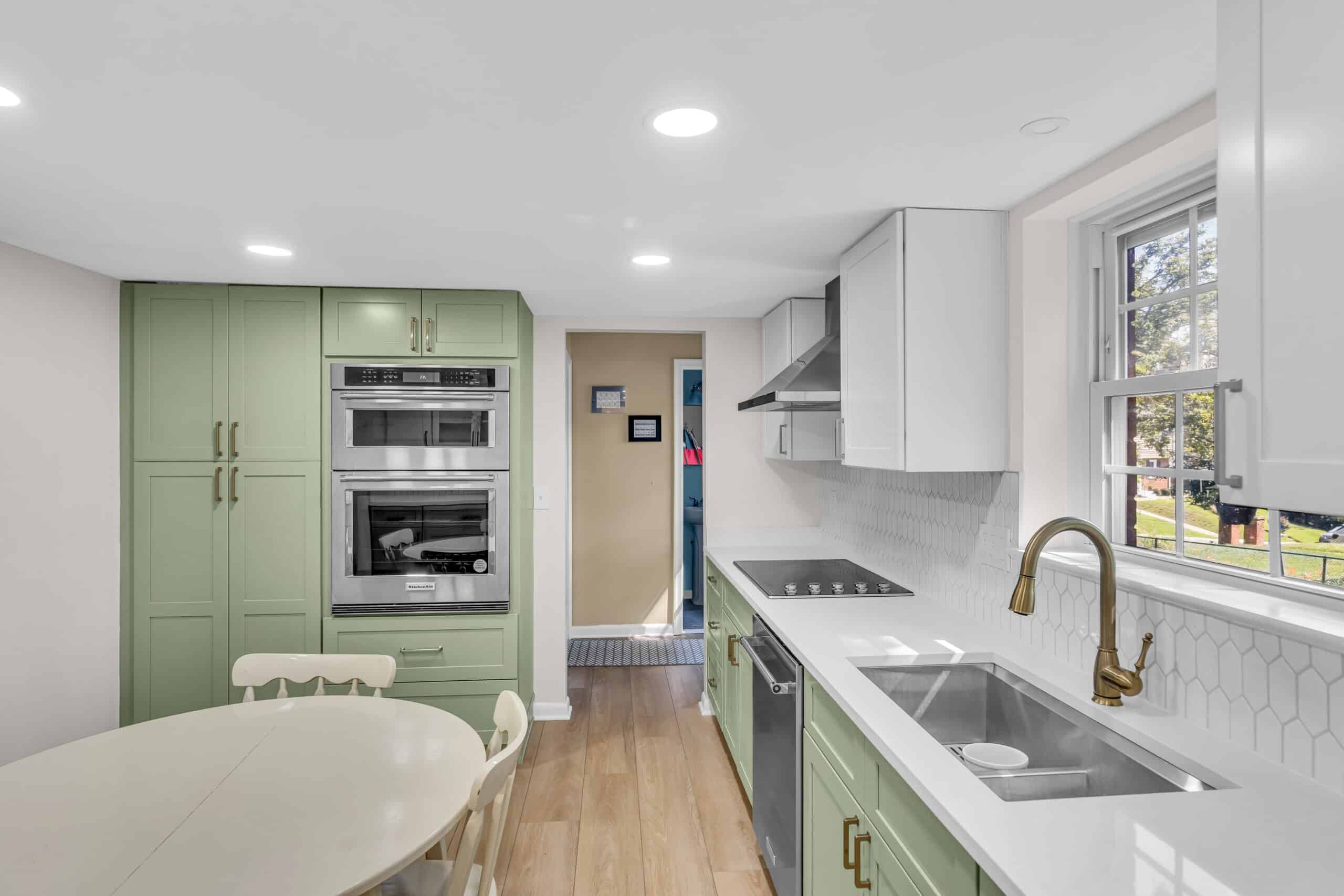 Deluxe white and green kitchen with shaker style cabinets
