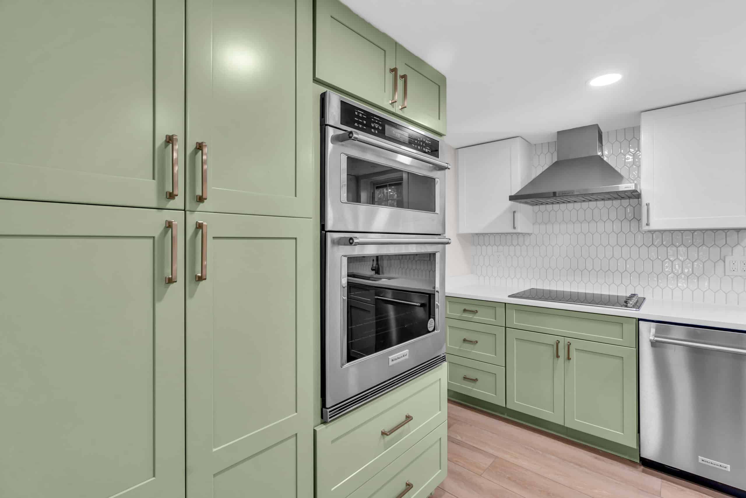 Deluxe white and green kitchen with shaker style cabinets