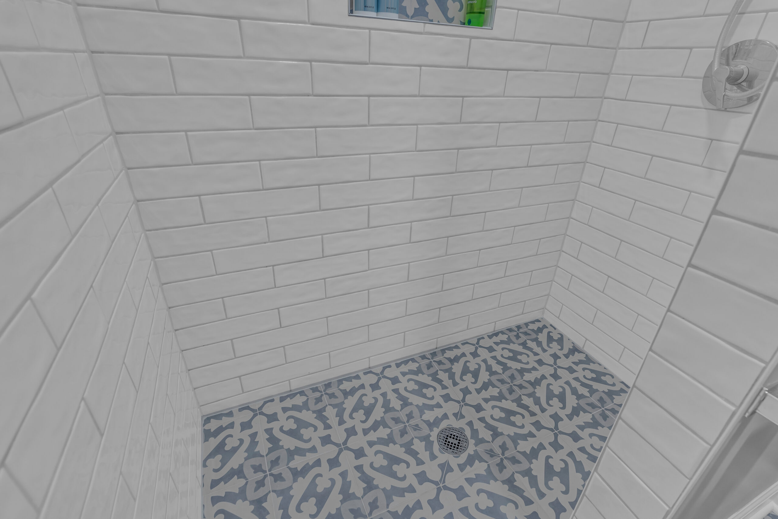 Walk-in shower view with tile flooring