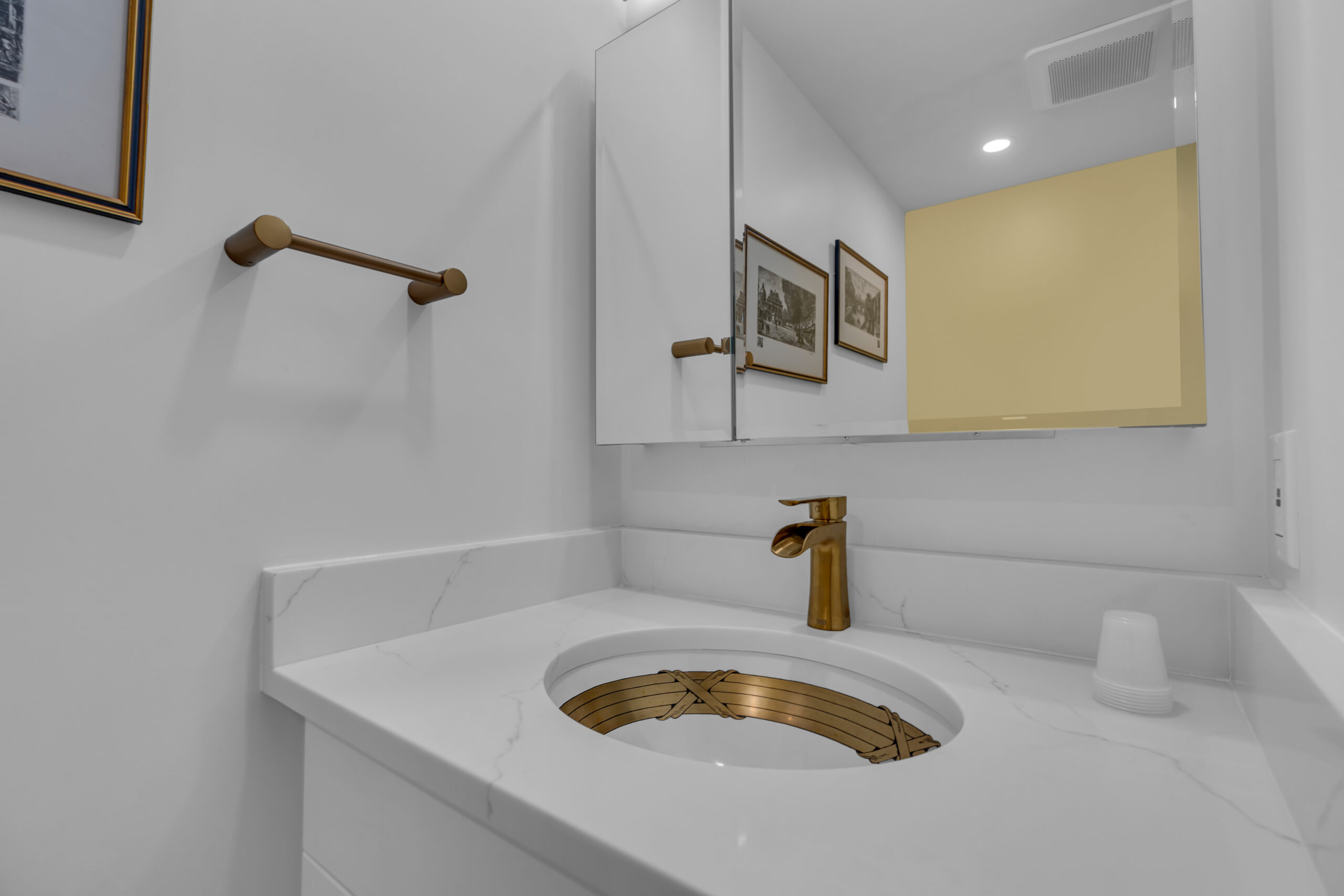 White vanity with gold sink and faucet