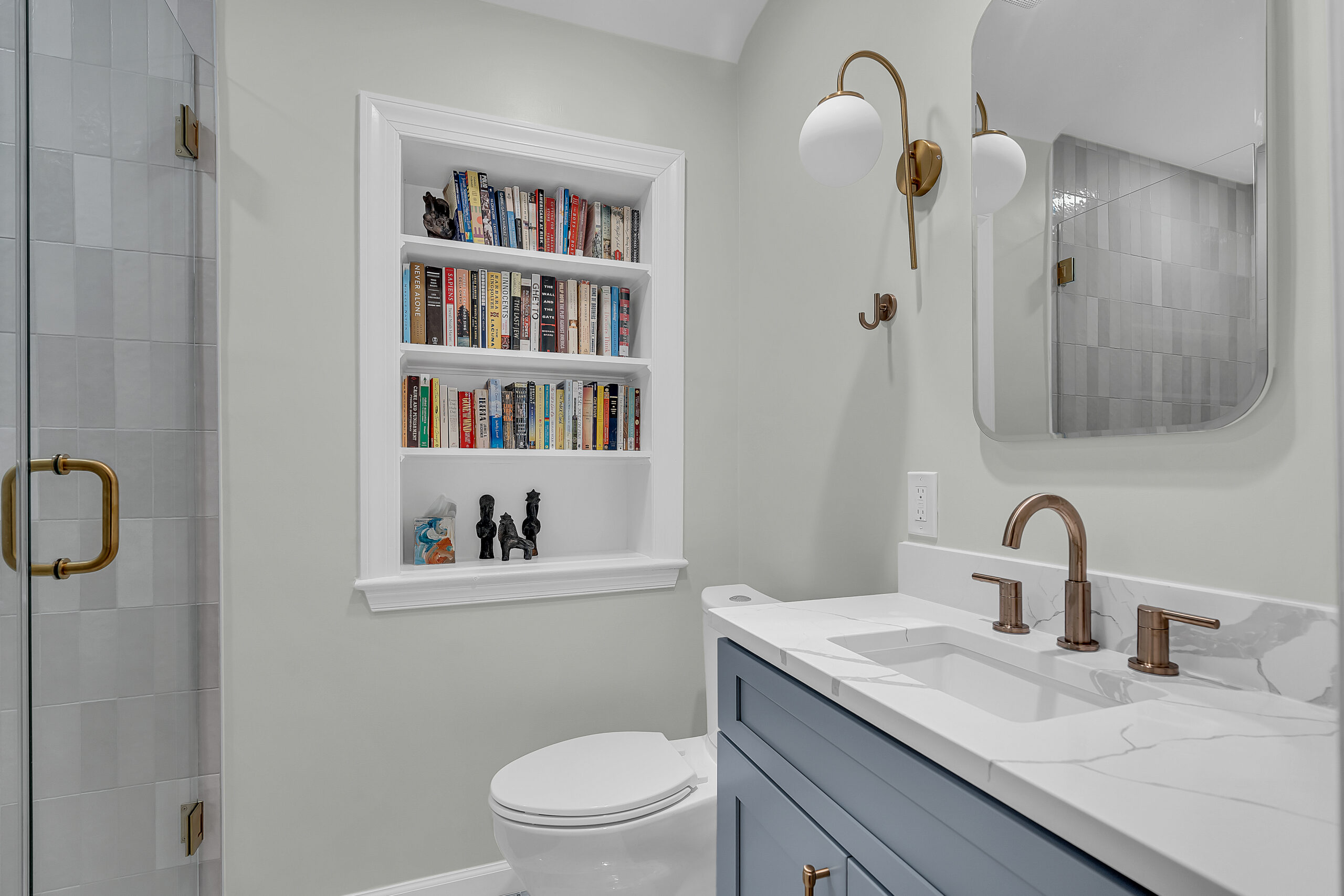 White bathroom style with light grey vanity, and a toilet