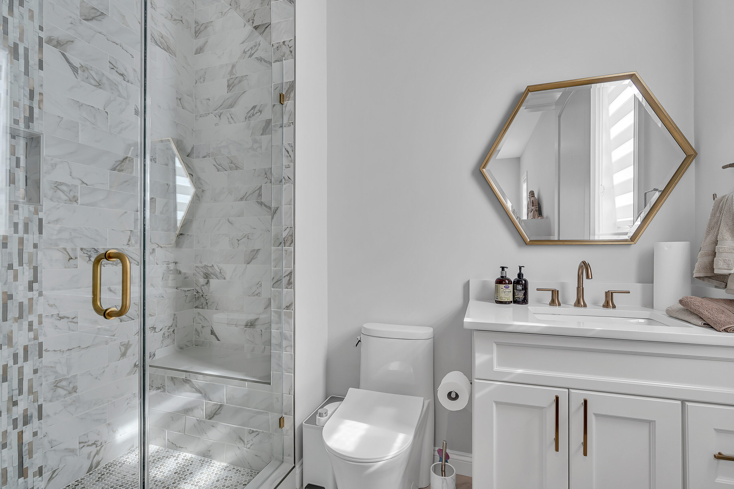 Elegant bathroom with walk-in shower, vanity, and toilet