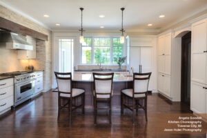 White kitchen design with brown flooring